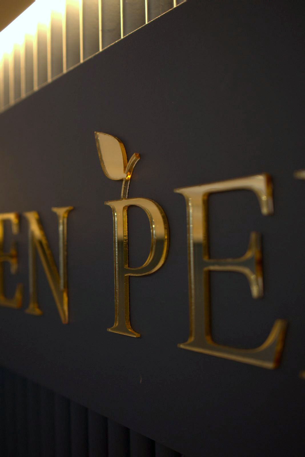 Raised gold EDEN PERFUMES lettering on the counter
